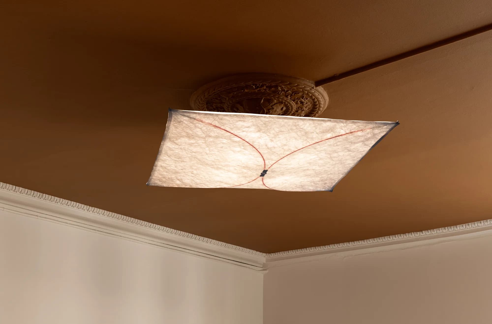 Ceiling detail at Alethia, Fiolstræde 14, Copenhagen: original stucco rosette, paper-sail lamp and terracotta ceiling in 19th-century building
